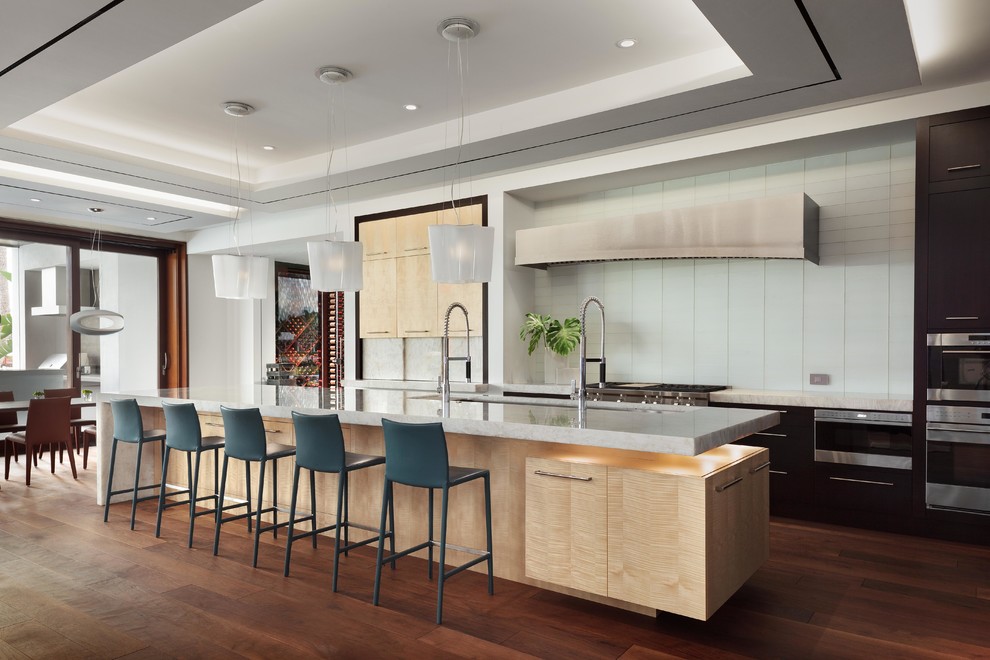Inspiration for a contemporary dark wood floor and brown floor eat-in kitchen remodel in Miami with an undermount sink, flat-panel cabinets, white backsplash, glass tile backsplash, stainless steel appliances and an island