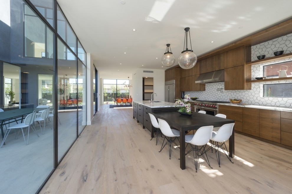 Large trendy single-wall light wood floor eat-in kitchen photo in San Francisco with a drop-in sink, flat-panel cabinets, medium tone wood cabinets, marble countertops, white backsplash, ceramic backsplash, stainless steel appliances and an island