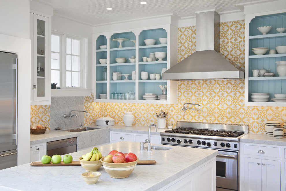 Example of a transitional kitchen design in Miami with white cabinets, yellow backsplash, stainless steel appliances and an island