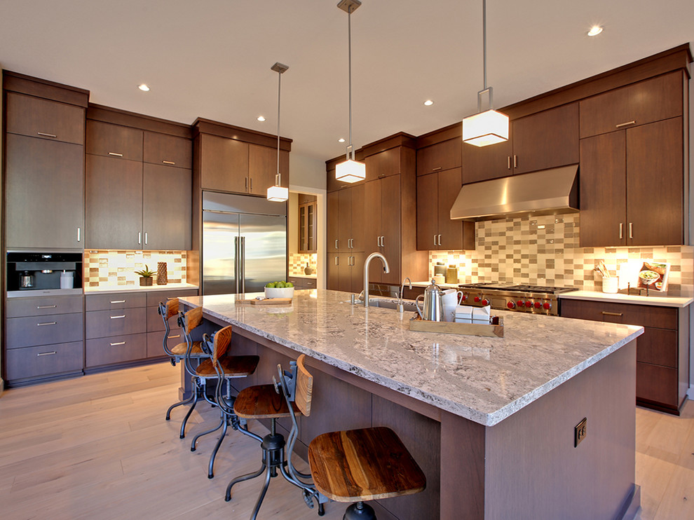 Inspiration for a large contemporary l-shaped light wood floor and beige floor open concept kitchen remodel in Portland with an undermount sink, flat-panel cabinets, medium tone wood cabinets, marble countertops, multicolored backsplash, stainless steel appliances, an island and limestone backsplash