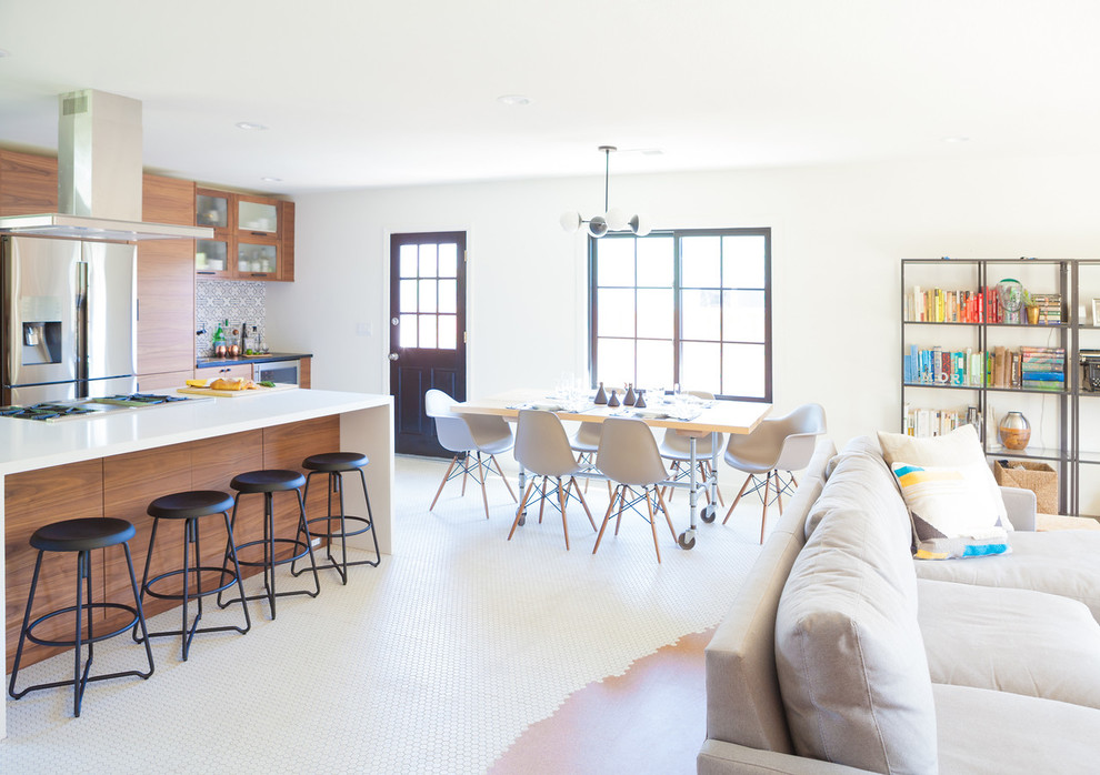Small midcentury l-shaped open plan kitchen in San Francisco with a belfast sink, flat-panel cabinets, medium wood cabinets, engineered stone countertops, multi-coloured splashback, ceramic splashback, stainless steel appliances, porcelain flooring, an island and white floors.