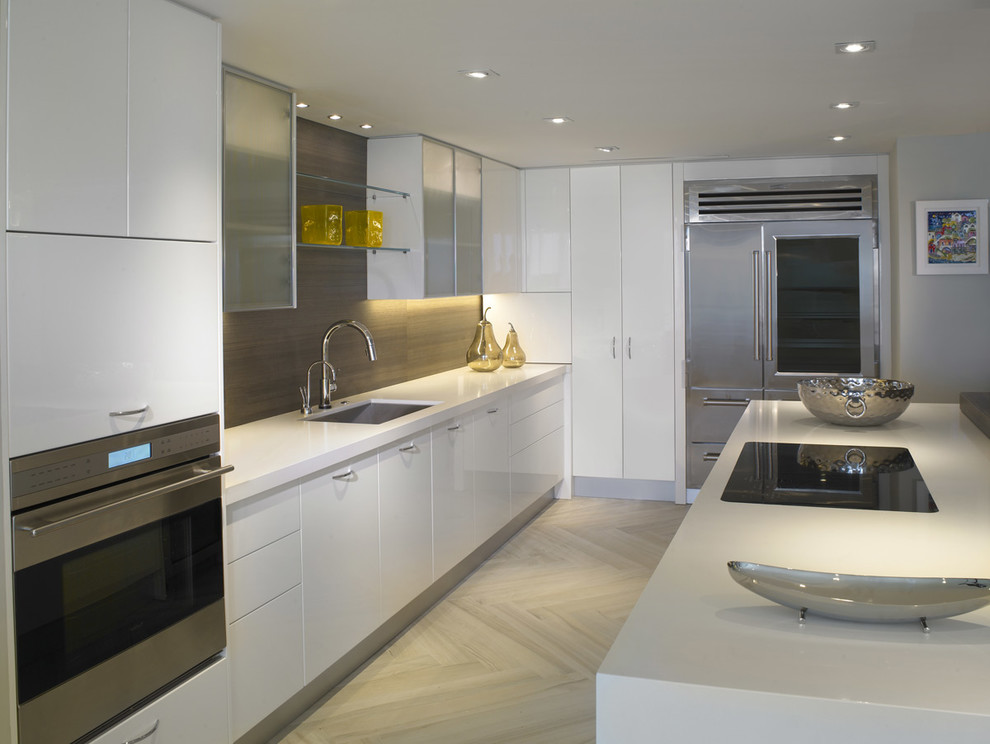 Example of a mid-sized minimalist single-wall porcelain tile and beige floor open concept kitchen design in Miami with an undermount sink, flat-panel cabinets, white cabinets, solid surface countertops, brown backsplash, wood backsplash, stainless steel appliances, a peninsula and white countertops