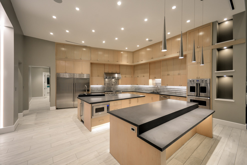 Design ideas for a large contemporary l-shaped kitchen/diner in Houston with an integrated sink, flat-panel cabinets, medium wood cabinets, engineered stone countertops, multi-coloured splashback, glass tiled splashback, stainless steel appliances, porcelain flooring and multiple islands.