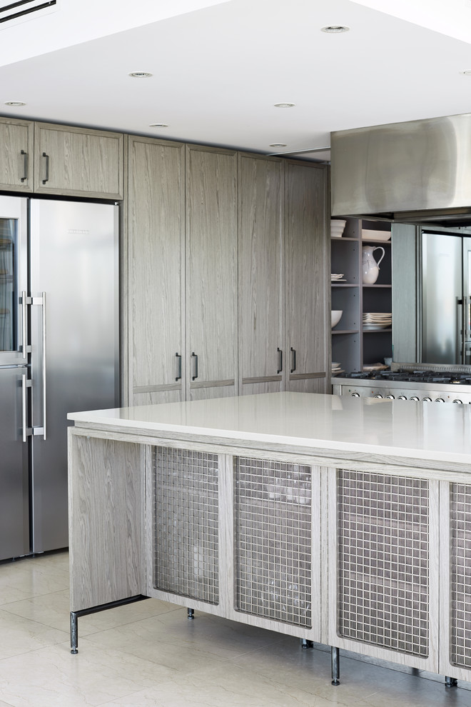 Large contemporary galley open plan kitchen in Sydney with a double-bowl sink, flat-panel cabinets, grey cabinets, concrete worktops, grey splashback, mirror splashback, stainless steel appliances, concrete flooring, an island, grey floors and grey worktops.