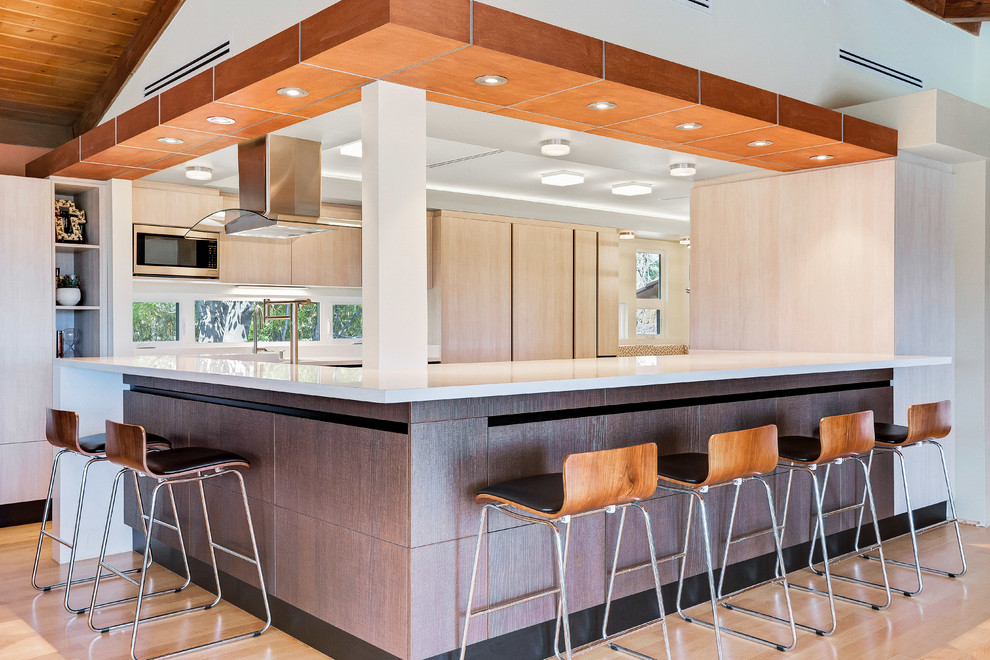 Inspiration for a medium sized contemporary u-shaped kitchen/diner in Orange County with flat-panel cabinets.
