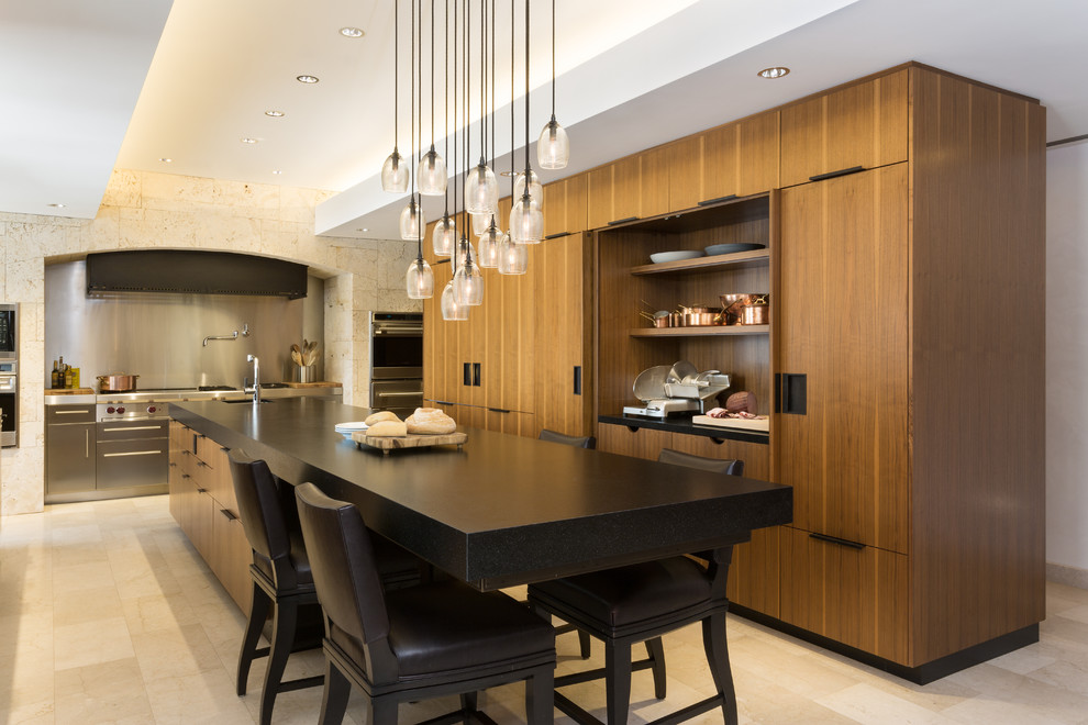 Eat-in kitchen - large contemporary single-wall porcelain tile eat-in kitchen idea in New York with granite countertops, flat-panel cabinets, medium tone wood cabinets, stainless steel appliances, an undermount sink and an island