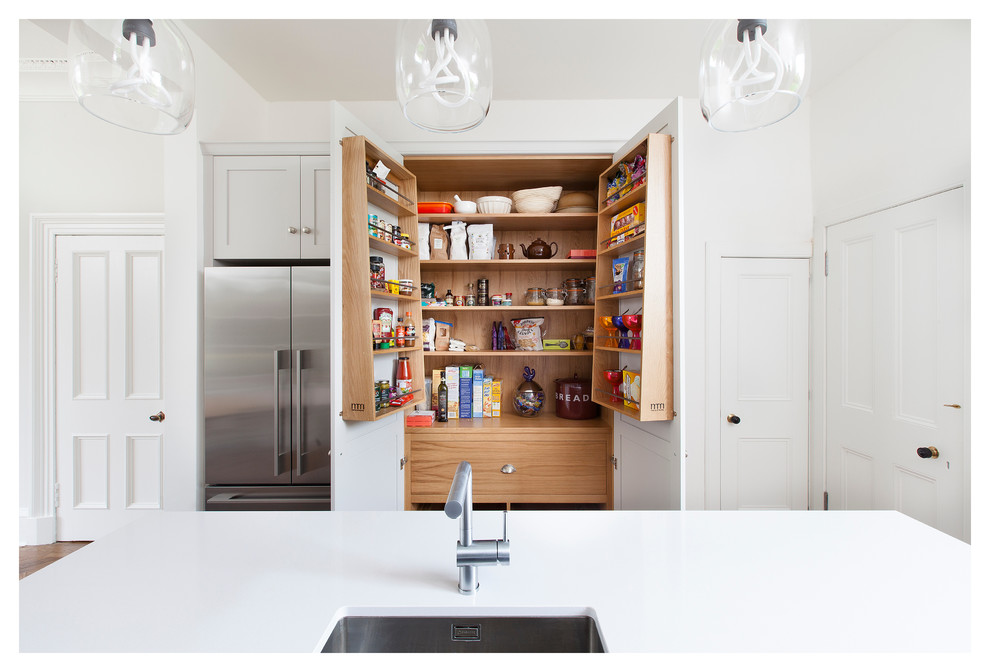 Contemporary kitchen pantry in Other with a submerged sink and stainless steel appliances.