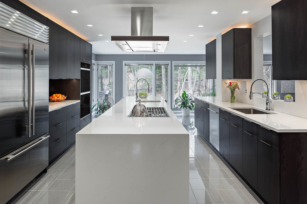 Photo of a large contemporary u-shaped kitchen in Other with a single-bowl sink, flat-panel cabinets, dark wood cabinets, engineered stone countertops, stainless steel appliances, marble flooring, an island, grey floors and white worktops.