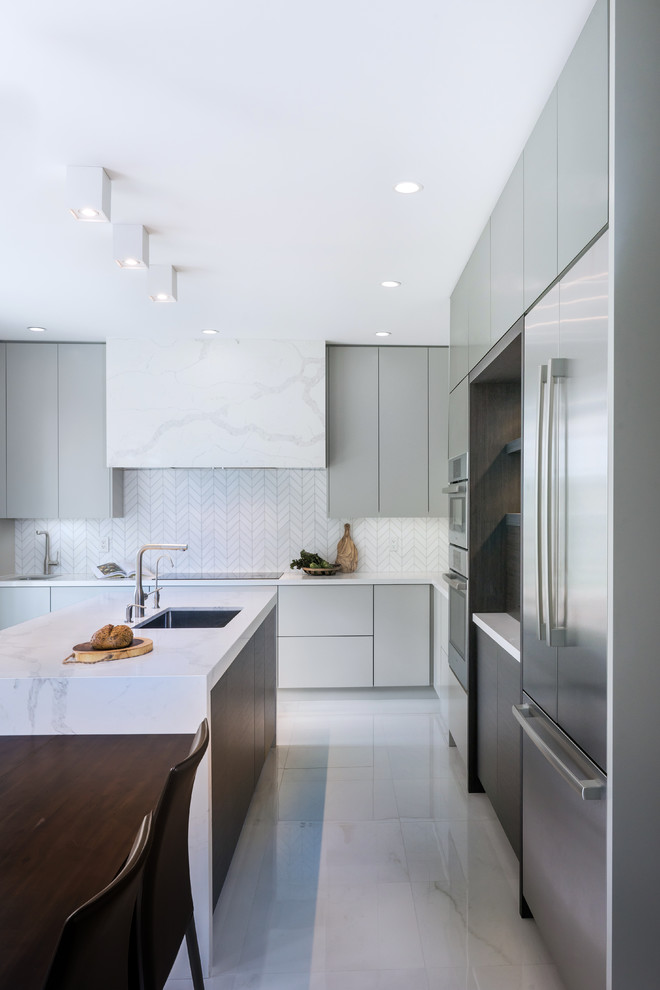 Example of a mid-sized minimalist l-shaped porcelain tile and white floor eat-in kitchen design in Toronto with an undermount sink, flat-panel cabinets, gray cabinets, quartz countertops, white backsplash, porcelain backsplash, stainless steel appliances, an island and white countertops