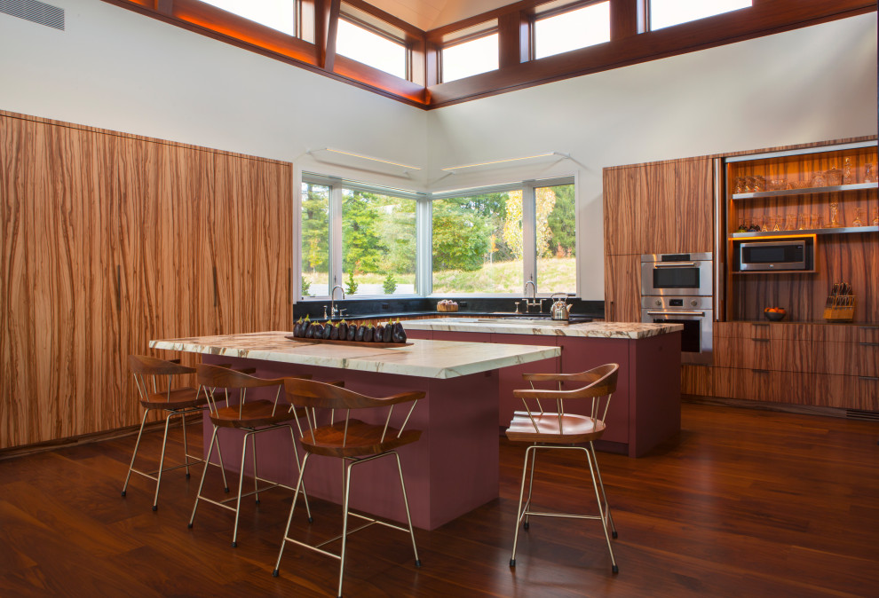 Inspiration for a large contemporary dark wood floor and vaulted ceiling eat-in kitchen remodel in Philadelphia with an undermount sink, flat-panel cabinets, medium tone wood cabinets, marble countertops, stainless steel appliances, two islands and white countertops