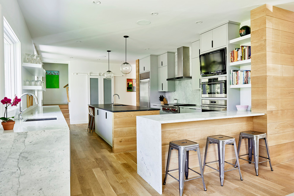 Large minimalist l-shaped medium tone wood floor and beige floor eat-in kitchen photo in Richmond with an undermount sink, flat-panel cabinets, white cabinets, marble countertops, gray backsplash, marble backsplash, stainless steel appliances and an island