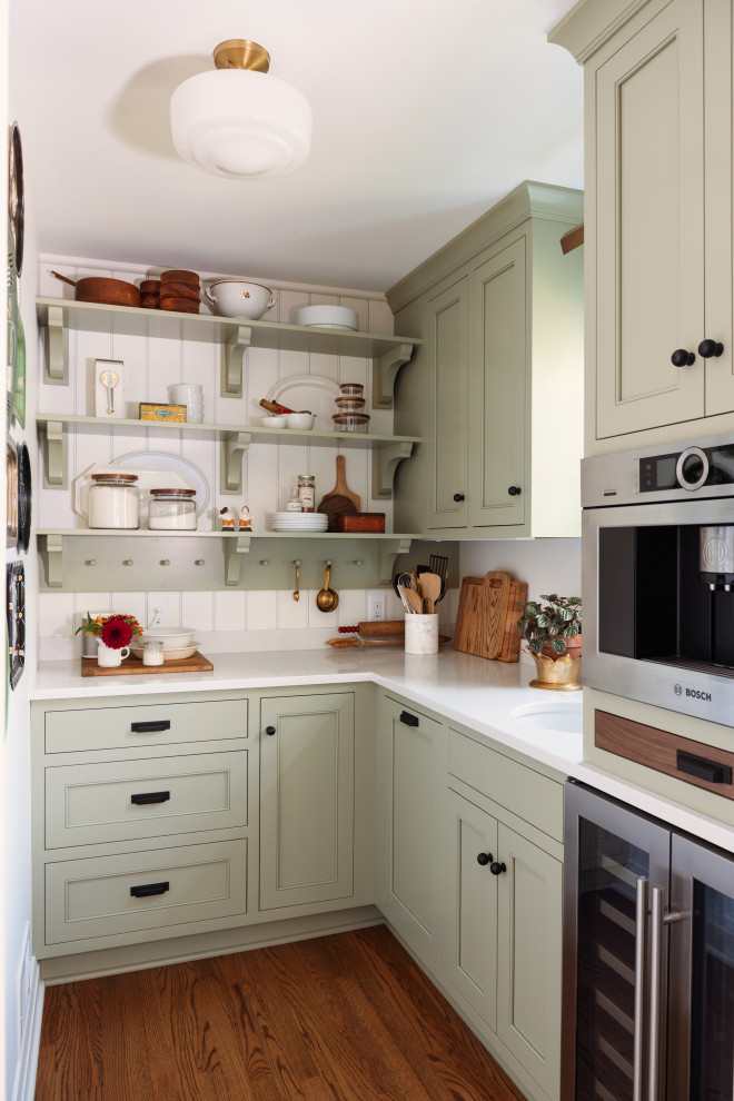 Inspiration for a classic l-shaped kitchen pantry in Other with a submerged sink, shaker cabinets, green cabinets, stainless steel appliances, medium hardwood flooring, no island, brown floors and white worktops.