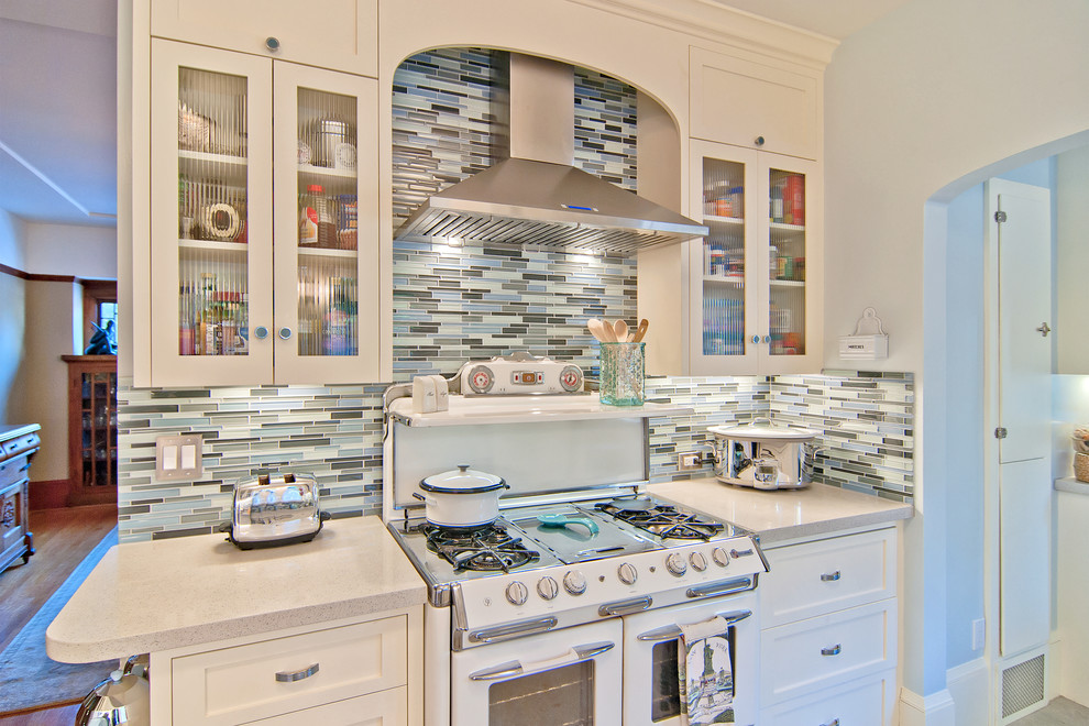 Elegant kitchen photo in San Francisco with matchstick tile backsplash, white appliances and multicolored backsplash