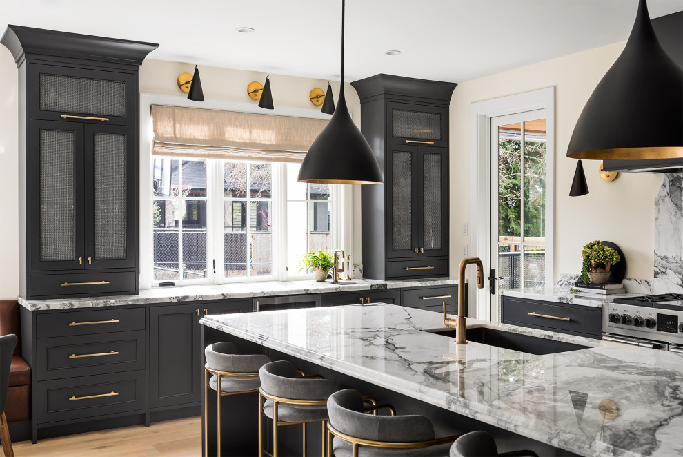Large transitional u-shaped light wood floor and brown floor eat-in kitchen photo in Vancouver with an undermount sink, recessed-panel cabinets, gray cabinets, marble countertops, white backsplash, granite backsplash, black appliances, an island and white countertops