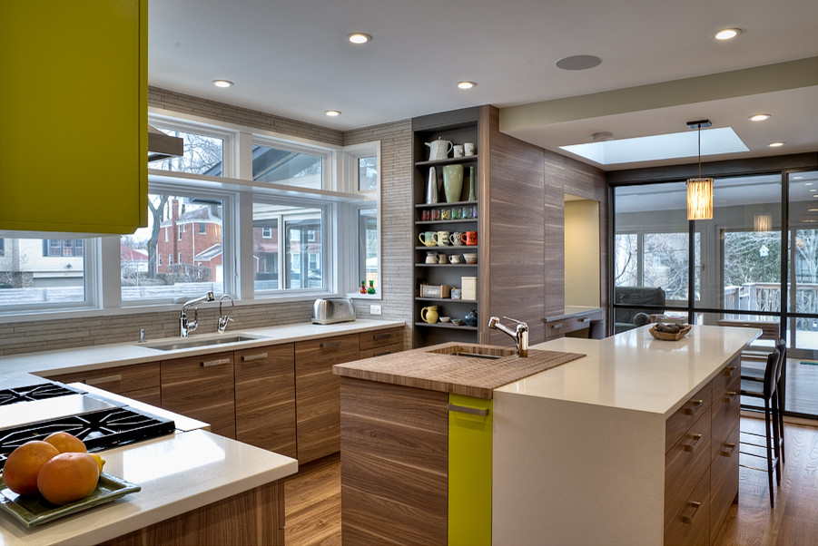 Large contemporary u-shaped kitchen/diner in Chicago with a submerged sink, flat-panel cabinets, medium wood cabinets, engineered stone countertops, beige splashback, mosaic tiled splashback, stainless steel appliances, medium hardwood flooring, an island and brown floors.