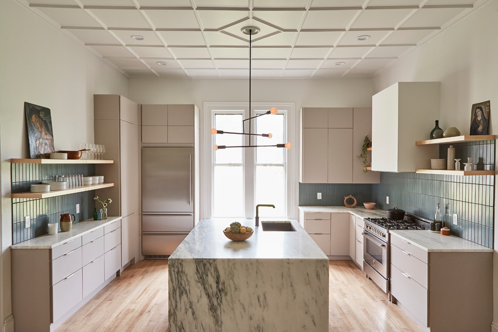 Large victorian u-shaped enclosed kitchen in Boston with a built-in sink, flat-panel cabinets, grey cabinets, marble worktops, blue splashback, ceramic splashback, stainless steel appliances, light hardwood flooring, an island, beige floors and white worktops.