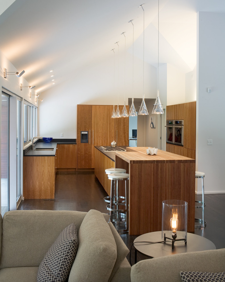 Inspiration for a modern open concept kitchen remodel in Kansas City with wood countertops