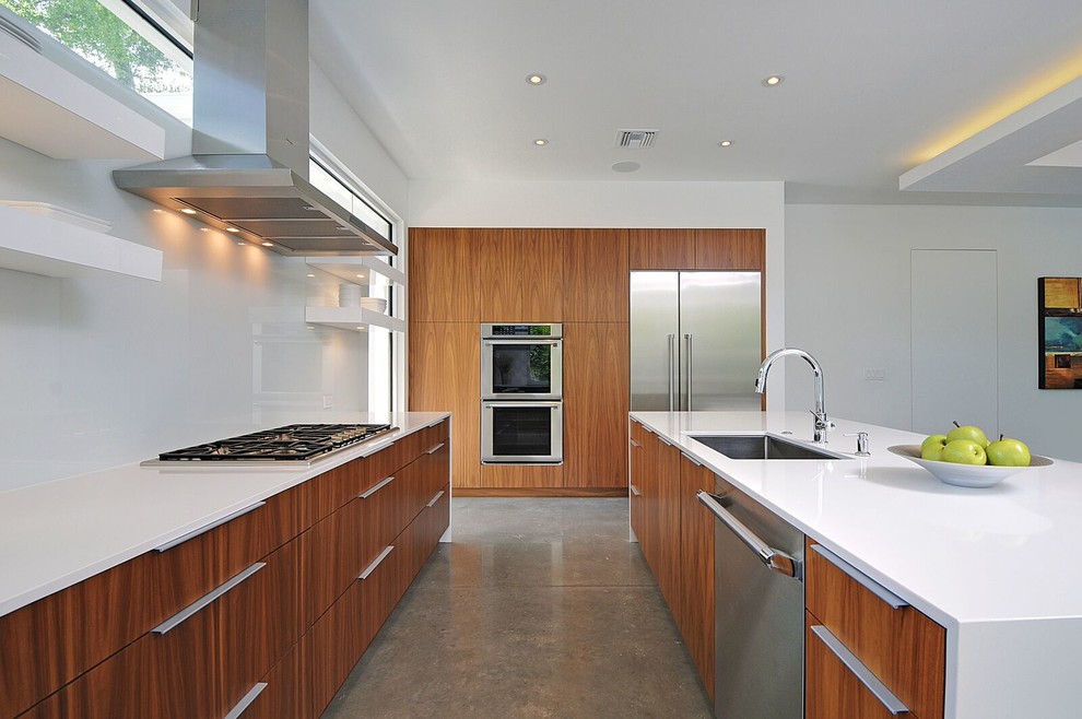 Exempel på ett stort modernt kök, med en undermonterad diskho, släta luckor, skåp i mellenmörkt trä, bänkskiva i kvarts, vitt stänkskydd, glaspanel som stänkskydd, vita vitvaror, betonggolv och en köksö