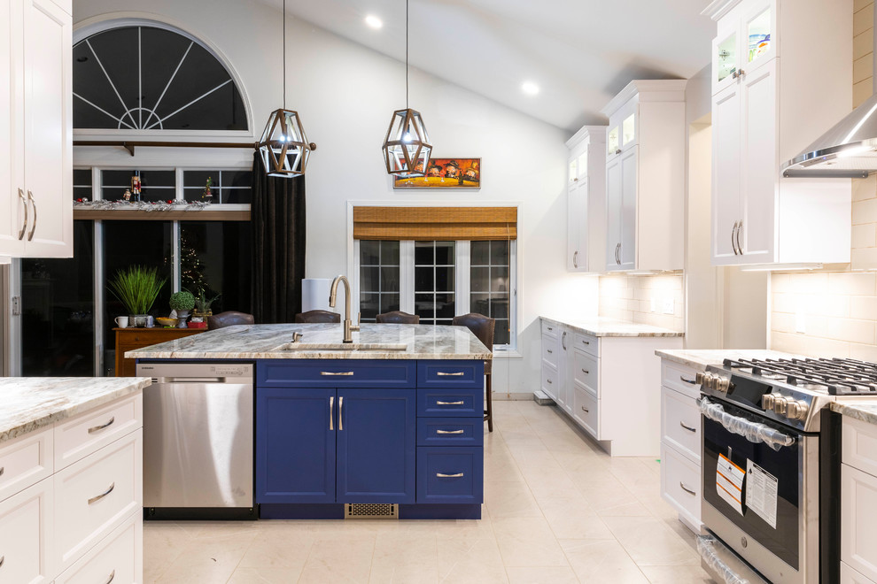 Large minimalist porcelain tile and beige floor kitchen photo in Ottawa with an undermount sink, shaker cabinets, granite countertops, white backsplash, porcelain backsplash, stainless steel appliances, an island, white countertops and blue cabinets