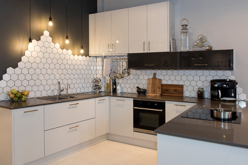 Inspiration for a medium sized contemporary grey and cream u-shaped open plan kitchen in Other with a built-in sink, flat-panel cabinets, beige cabinets, quartz worktops, porcelain splashback, stainless steel appliances, no island and white splashback.