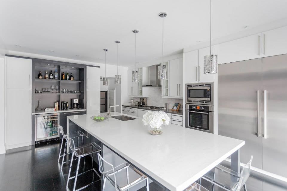 Example of a large minimalist u-shaped dark wood floor eat-in kitchen design in Toronto with an undermount sink, glass-front cabinets, white cabinets, quartzite countertops, white backsplash, stone tile backsplash, stainless steel appliances and two islands