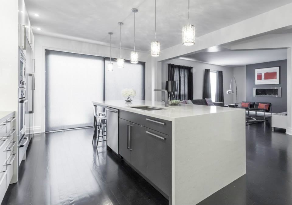 Inspiration for a large modern u-shaped dark wood floor eat-in kitchen remodel in Toronto with an undermount sink, glass-front cabinets, white cabinets, quartzite countertops, white backsplash, stone tile backsplash, stainless steel appliances and two islands