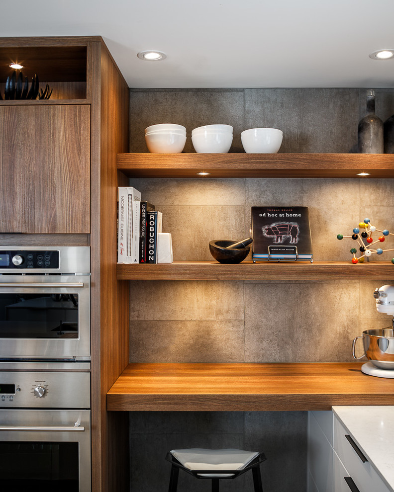 Example of a trendy eat-in kitchen design in Ottawa with an undermount sink, flat-panel cabinets, white cabinets, quartz countertops, subway tile backsplash and stainless steel appliances