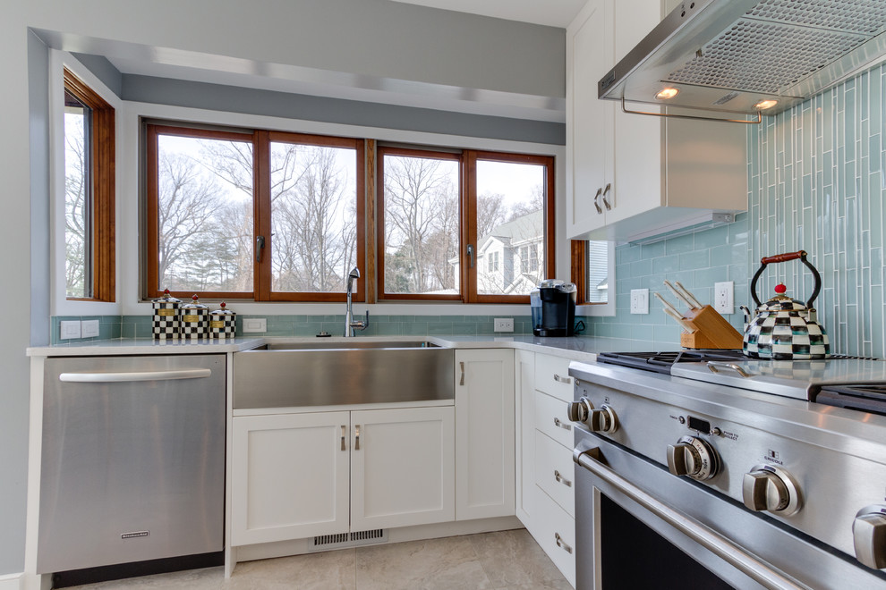 Design ideas for a classic u-shaped kitchen/diner in DC Metro with a belfast sink, shaker cabinets, white cabinets, engineered stone countertops, blue splashback, metro tiled splashback and stainless steel appliances.