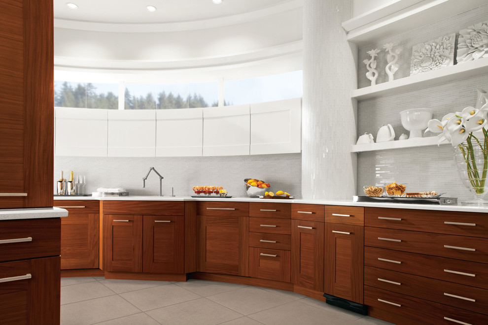 Inspiration for a large modern u-shaped kitchen in New York with medium wood cabinets, marble worktops, white splashback, glass tiled splashback, stainless steel appliances, an island, a built-in sink, flat-panel cabinets, cement flooring and grey floors.