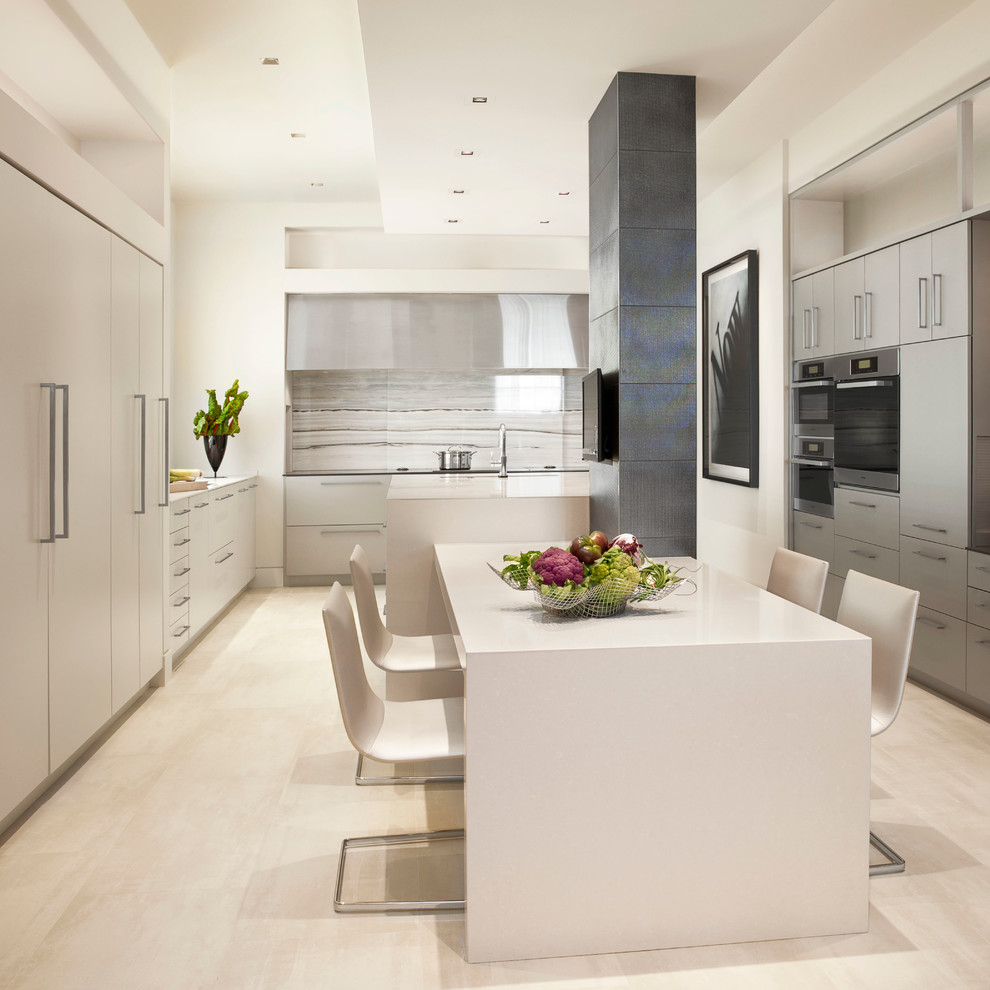 Inspiration for a contemporary u-shaped kitchen/diner in St Louis with flat-panel cabinets, white cabinets, white splashback, stone slab splashback, stainless steel appliances and an island.