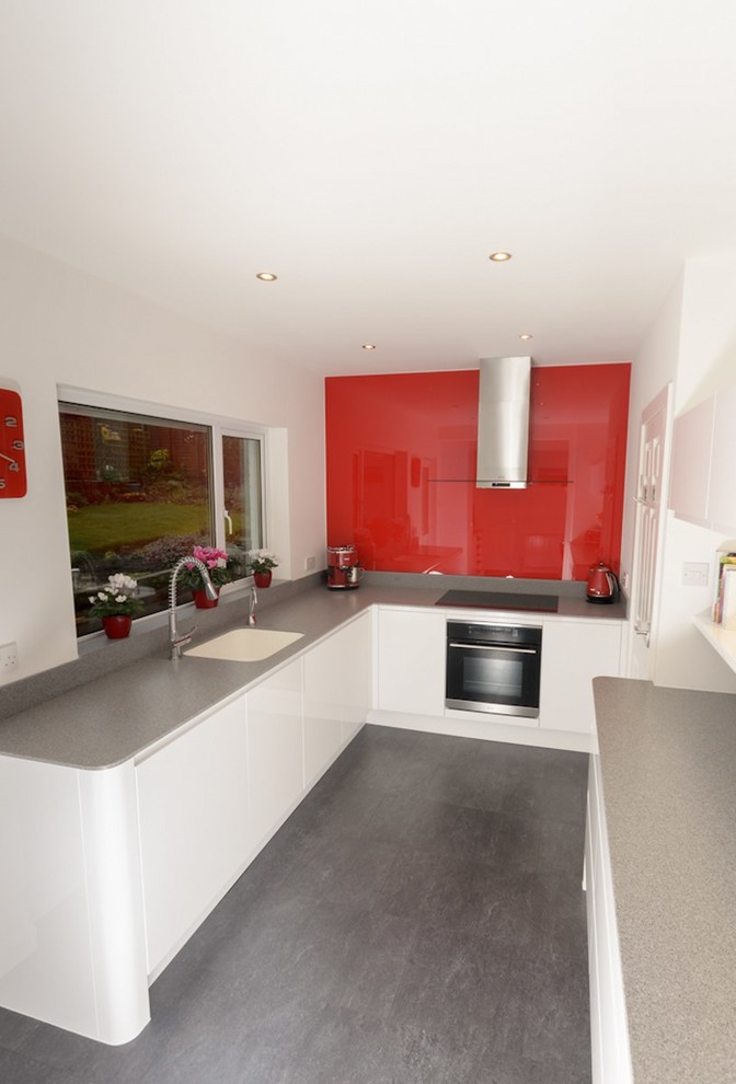Modern white kitchen with accent red splashback Contemporain