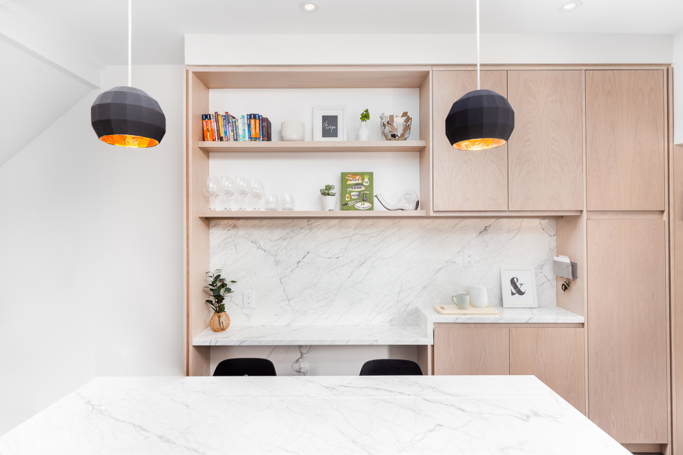 Mid-sized minimalist u-shaped eat-in kitchen photo in Toronto with an island, flat-panel cabinets, light wood cabinets, white backsplash and white countertops