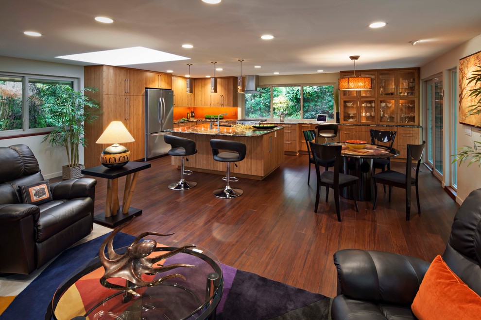 Large minimalist l-shaped bamboo floor open concept kitchen photo in Seattle with an undermount sink, flat-panel cabinets, medium tone wood cabinets, granite countertops, orange backsplash and an island