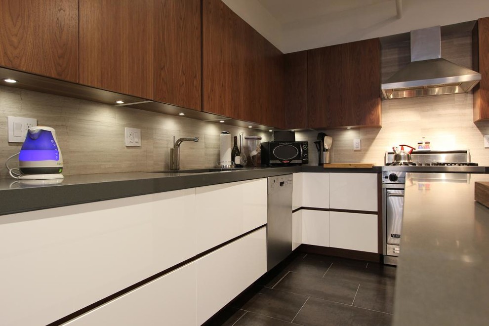 This is an example of a small modern l-shaped kitchen in New York with flat-panel cabinets, white cabinets, granite worktops, grey splashback, stainless steel appliances and an island.