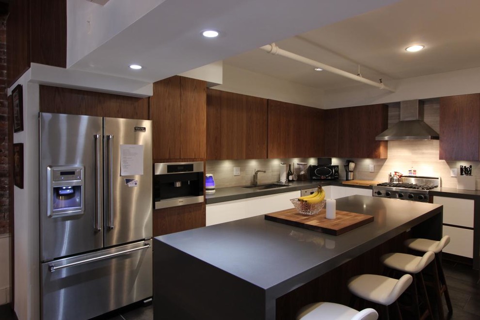Inspiration for a small modern l-shaped kitchen remodel in New York with flat-panel cabinets, white cabinets, concrete countertops, gray backsplash, stainless steel appliances and an island