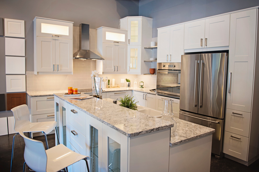 Inspiration for a mid-sized transitional l-shaped eat-in kitchen remodel in Nashville with a farmhouse sink, white cabinets, quartz countertops, gray backsplash and an island