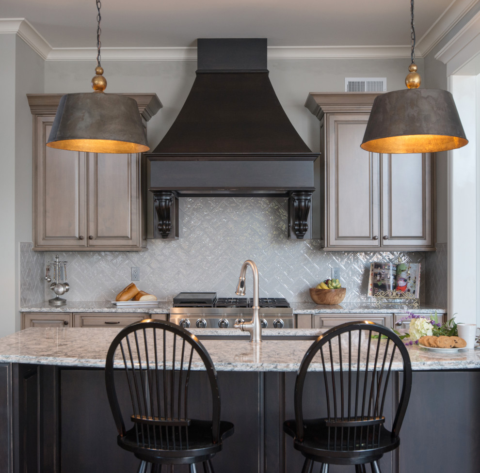 Example of a mid-sized classic kitchen design in Kansas City with raised-panel cabinets, beige cabinets, quartz countertops, glass tile backsplash, paneled appliances and an island