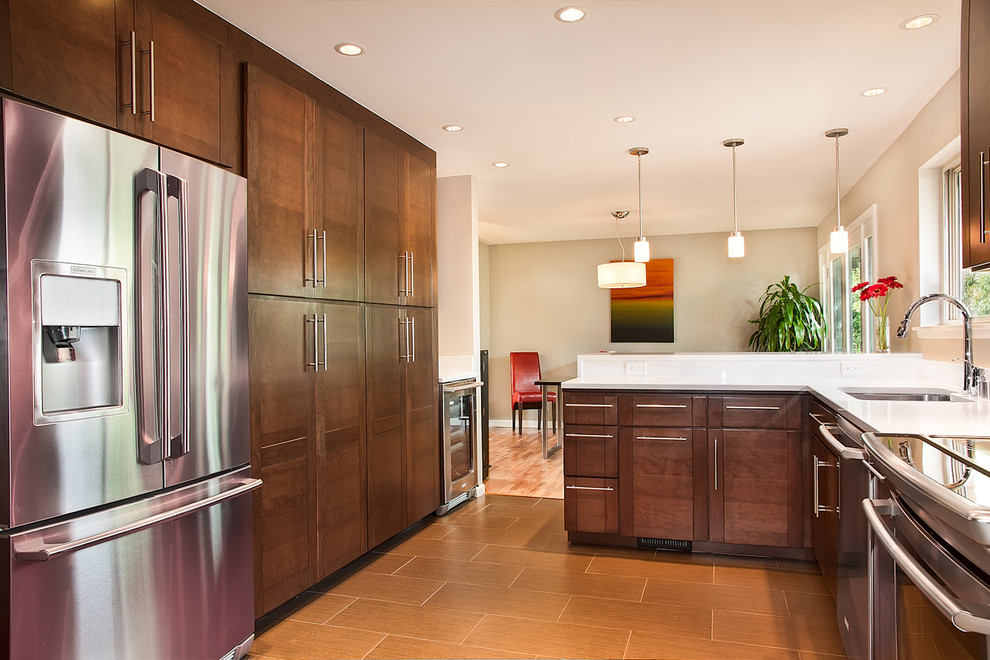 Photo of a contemporary u-shaped kitchen in Other with stainless steel appliances.