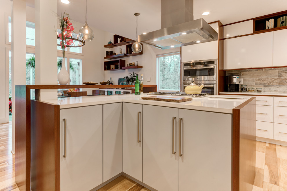 Inspiration for a large modern l-shaped light wood floor eat-in kitchen remodel in Los Angeles with an undermount sink, flat-panel cabinets, white cabinets, quartzite countertops, porcelain backsplash, stainless steel appliances, an island and blue backsplash