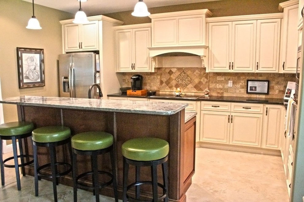 Bild på ett vintage kök, med en undermonterad diskho, luckor med upphöjd panel, granitbänkskiva och rostfria vitvaror