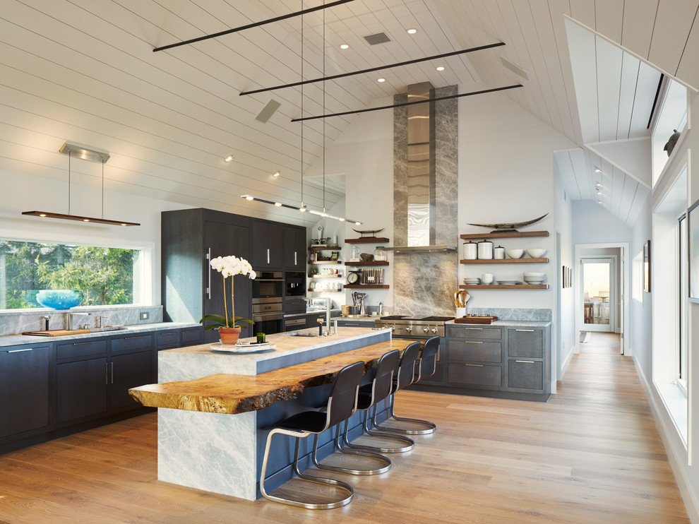 Example of a large trendy l-shaped light wood floor and beige floor eat-in kitchen design in New York with an undermount sink, flat-panel cabinets, gray backsplash, stainless steel appliances, an island, quartz countertops, marble backsplash and gray cabinets