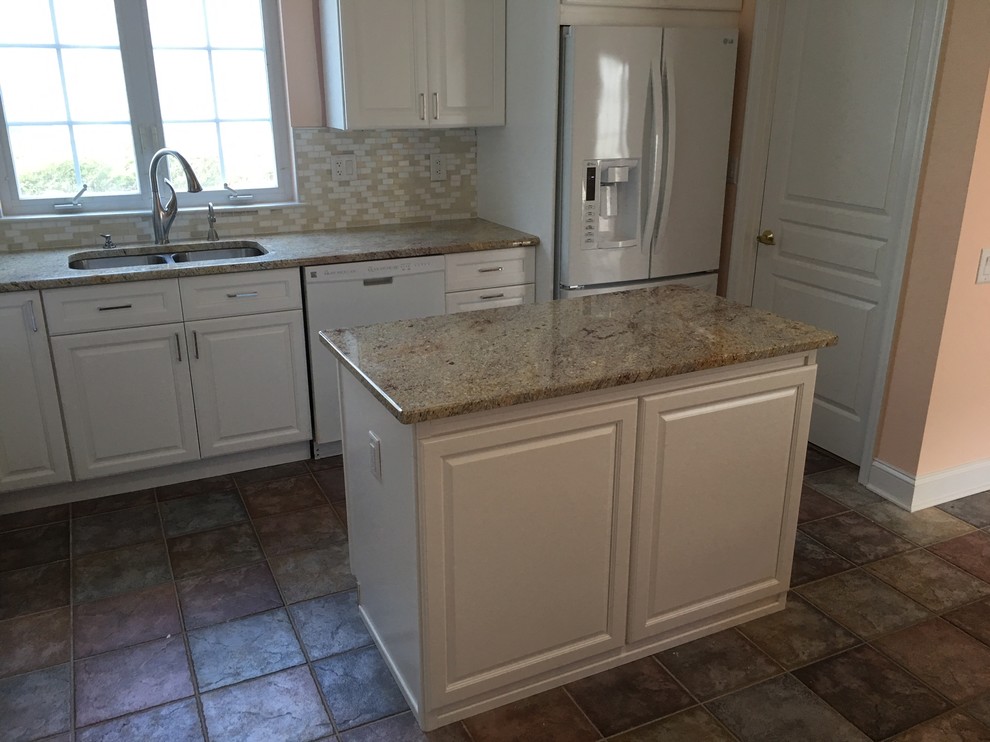 Mid-sized elegant l-shaped light wood floor eat-in kitchen photo in Newark with a double-bowl sink, raised-panel cabinets, white cabinets, granite countertops, beige backsplash, matchstick tile backsplash, white appliances and an island