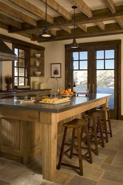 This is an example of a medium sized rustic galley enclosed kitchen in New York with a submerged sink, shaker cabinets, medium wood cabinets, stainless steel worktops, metallic splashback, stainless steel appliances, slate flooring, an island and brown floors.