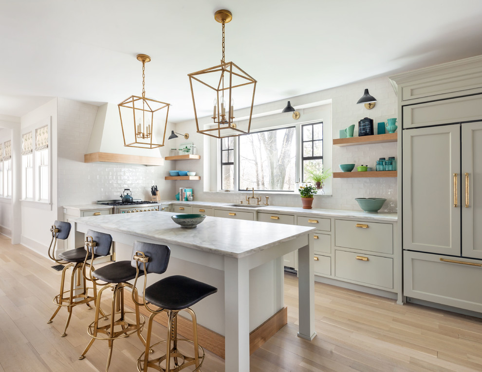 Kitchen - traditional l-shaped light wood floor and beige floor kitchen idea in New York with a single-bowl sink, gray cabinets, white backsplash, paneled appliances, an island and gray countertops
