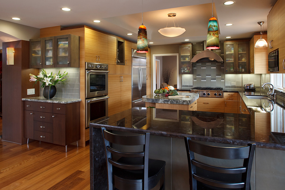 Example of a mid-sized trendy u-shaped medium tone wood floor open concept kitchen design in San Francisco with a single-bowl sink, flat-panel cabinets, light wood cabinets, marble countertops, gray backsplash, glass tile backsplash, stainless steel appliances and an island