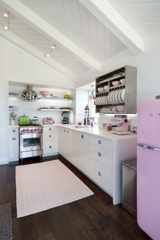 Trendy l-shaped dark wood floor open concept kitchen photo in Santa Barbara with flat-panel cabinets, white cabinets, no island, an undermount sink, solid surface countertops, white backsplash and colored appliances