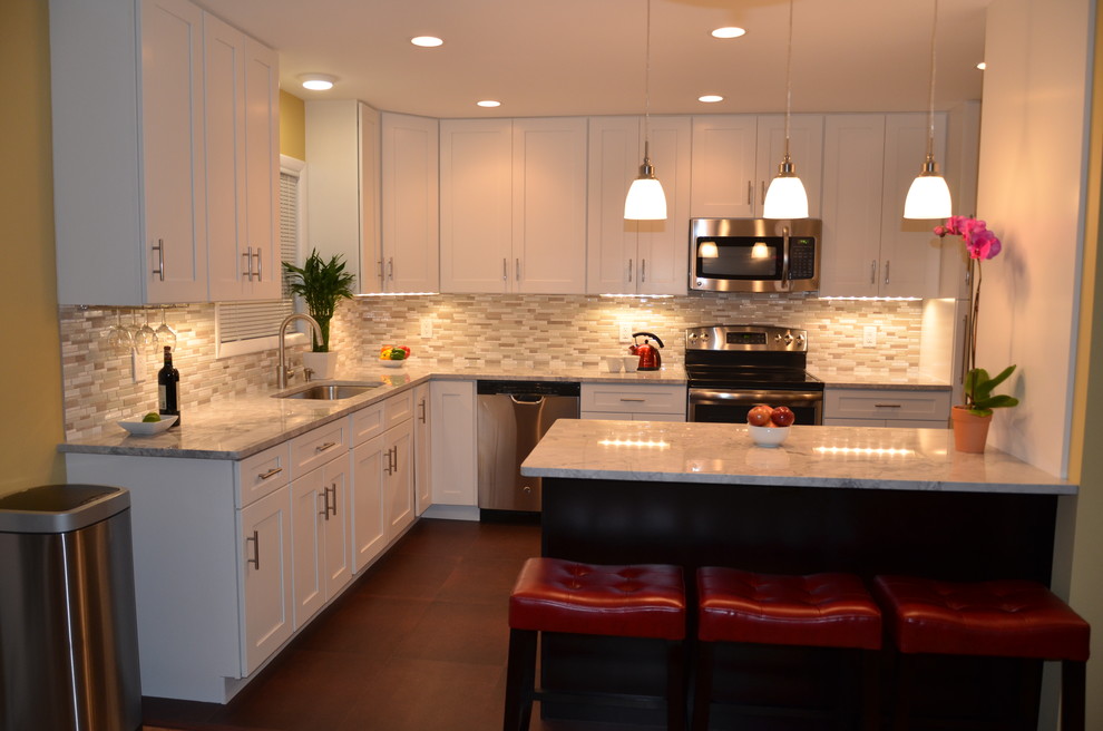 Inspiration for a mid-sized transitional l-shaped eat-in kitchen remodel in DC Metro with shaker cabinets, white cabinets, beige backsplash, stainless steel appliances and an island