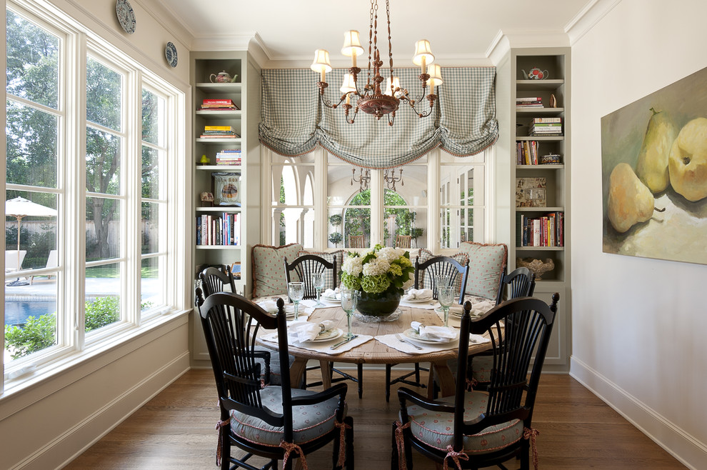 Mid-sized elegant medium tone wood floor enclosed dining room photo in Dallas