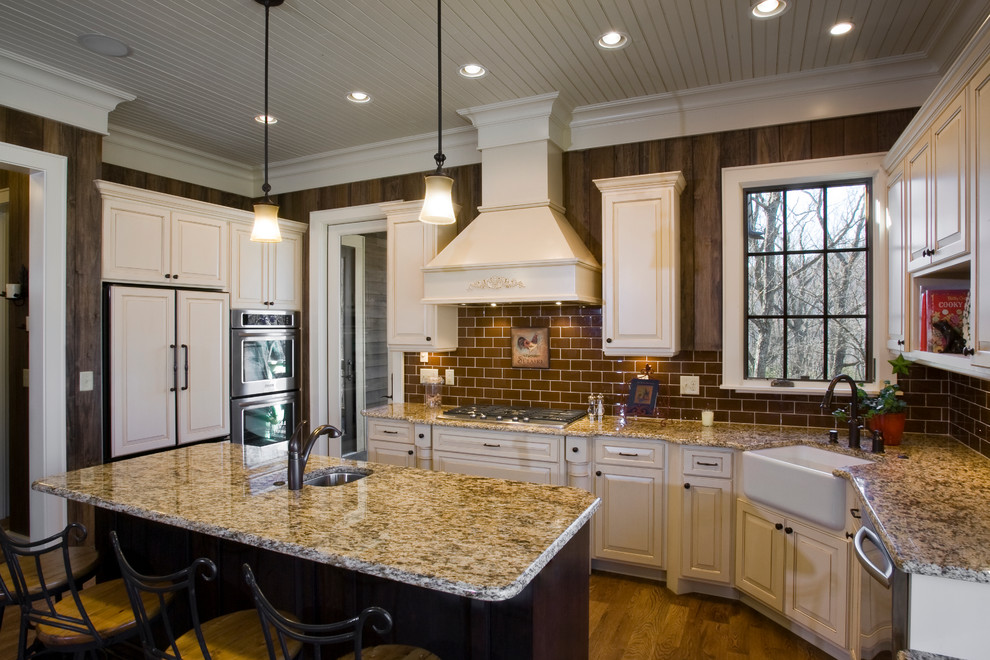 Open concept kitchen - mid-sized rustic single-wall light wood floor open concept kitchen idea in Other with an integrated sink, beaded inset cabinets, white cabinets, granite countertops, red backsplash, ceramic backsplash, white appliances and an island
