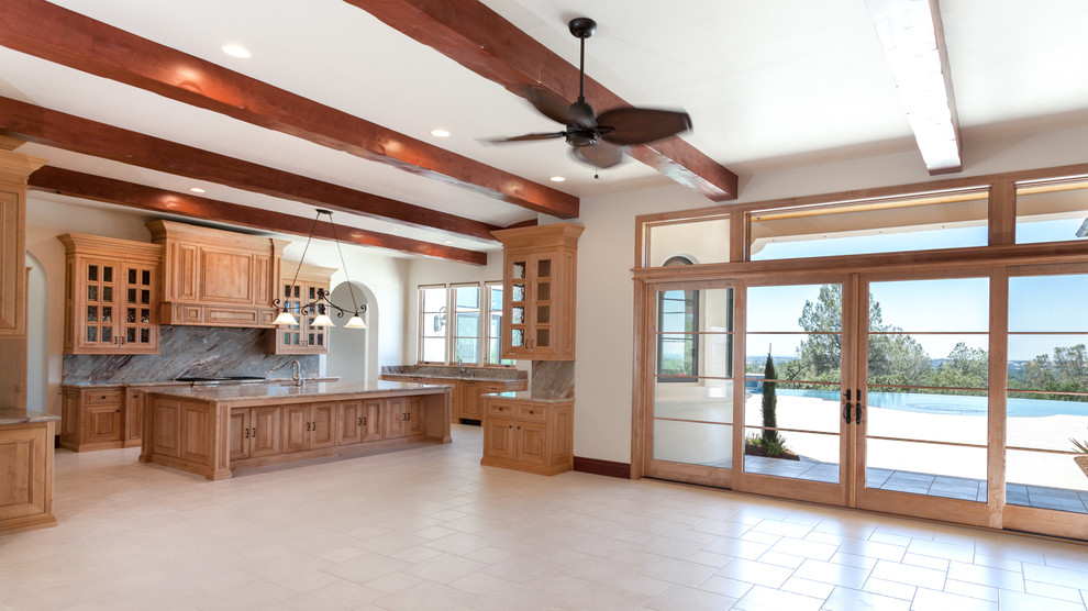 Large tuscan ceramic tile eat-in kitchen photo in Sacramento with an undermount sink, raised-panel cabinets, light wood cabinets, quartzite countertops, stone tile backsplash, paneled appliances and an island